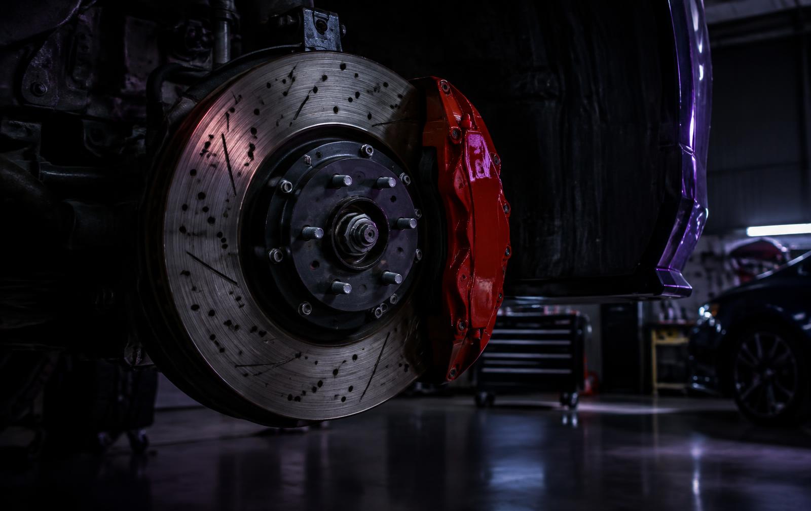 Close-up of a disc brake rotor and caliper (illustrative image)